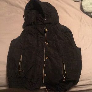 Small Black Calvin Klein Vest with gold accents.